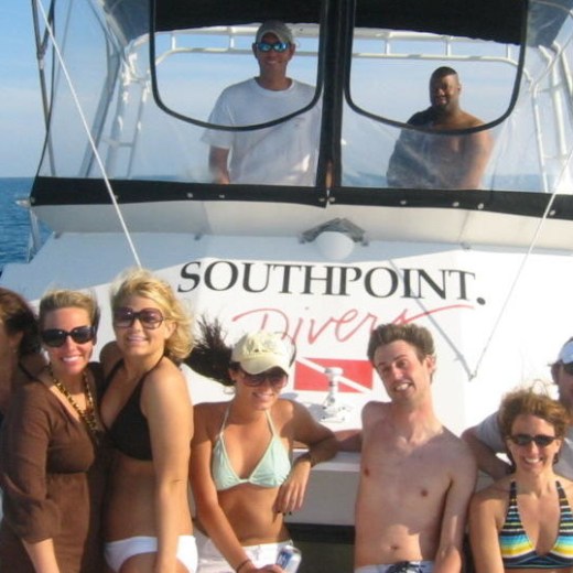 a group of people standing next to a body of water